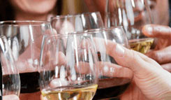 Guests at a table cheers with white wine glasses