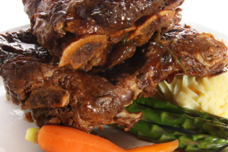 Red Wine Braised short ribs recipe plated with a carrot